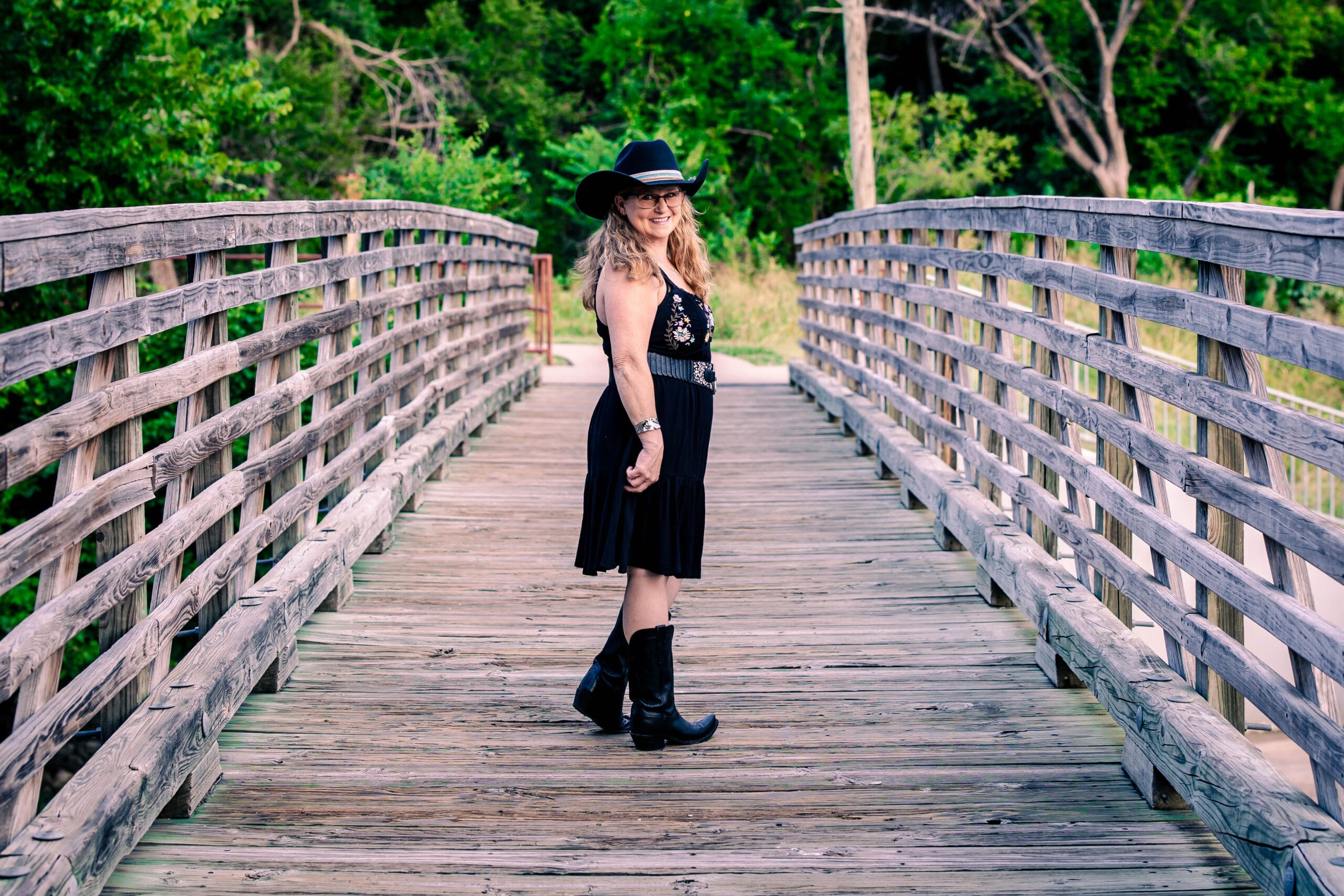 Theresa walking a park bridge at Holland Lake Park with Candids by Cunningham